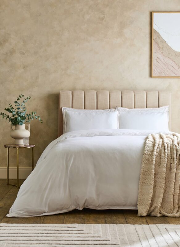 Hotel bed with upholstered headboard