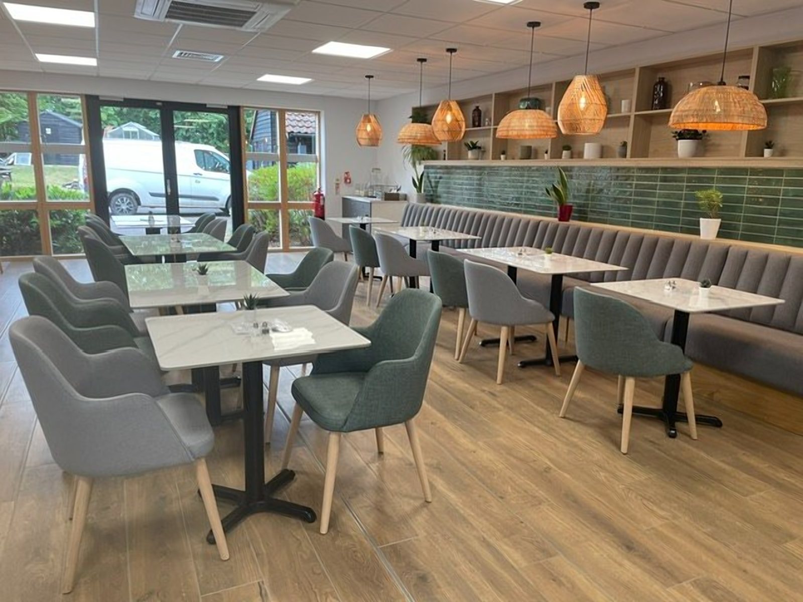 Hospice cafe furniture at Farleigh Hospice with a grey fluted banquette and sage chairs