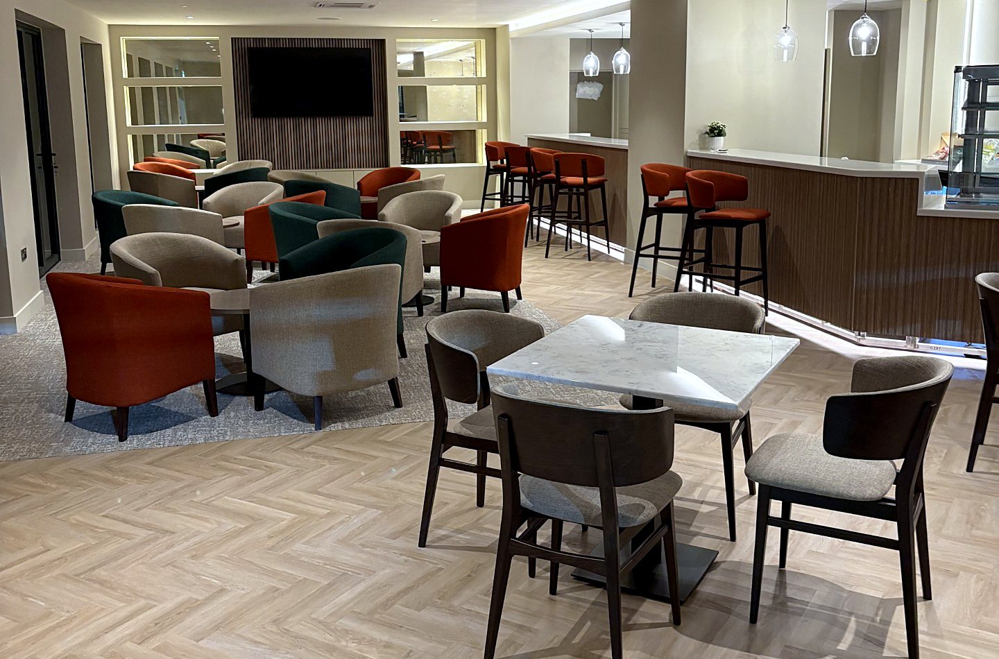 Tennis club furniture at Bramhall Lane with green, terracotta and linen tub chairs